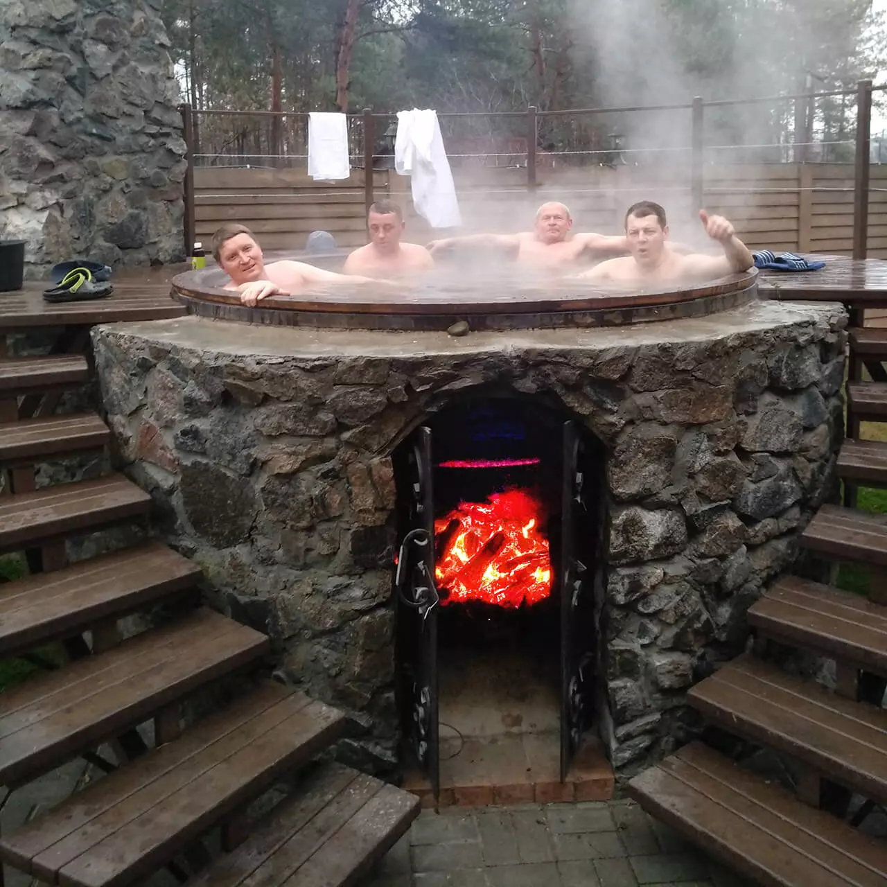 4 men soaking in outdoor tub