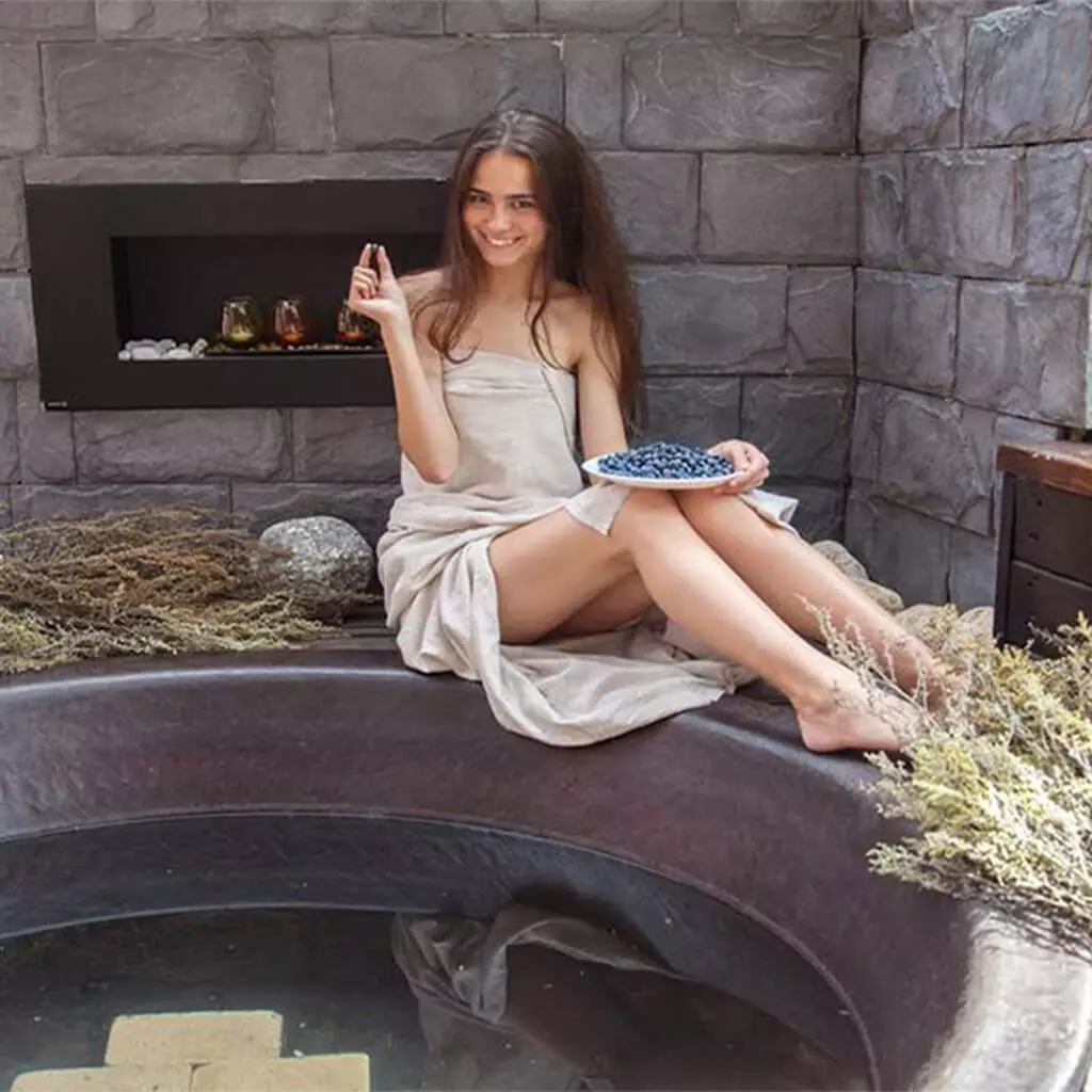 girl sitting near hot iron tub