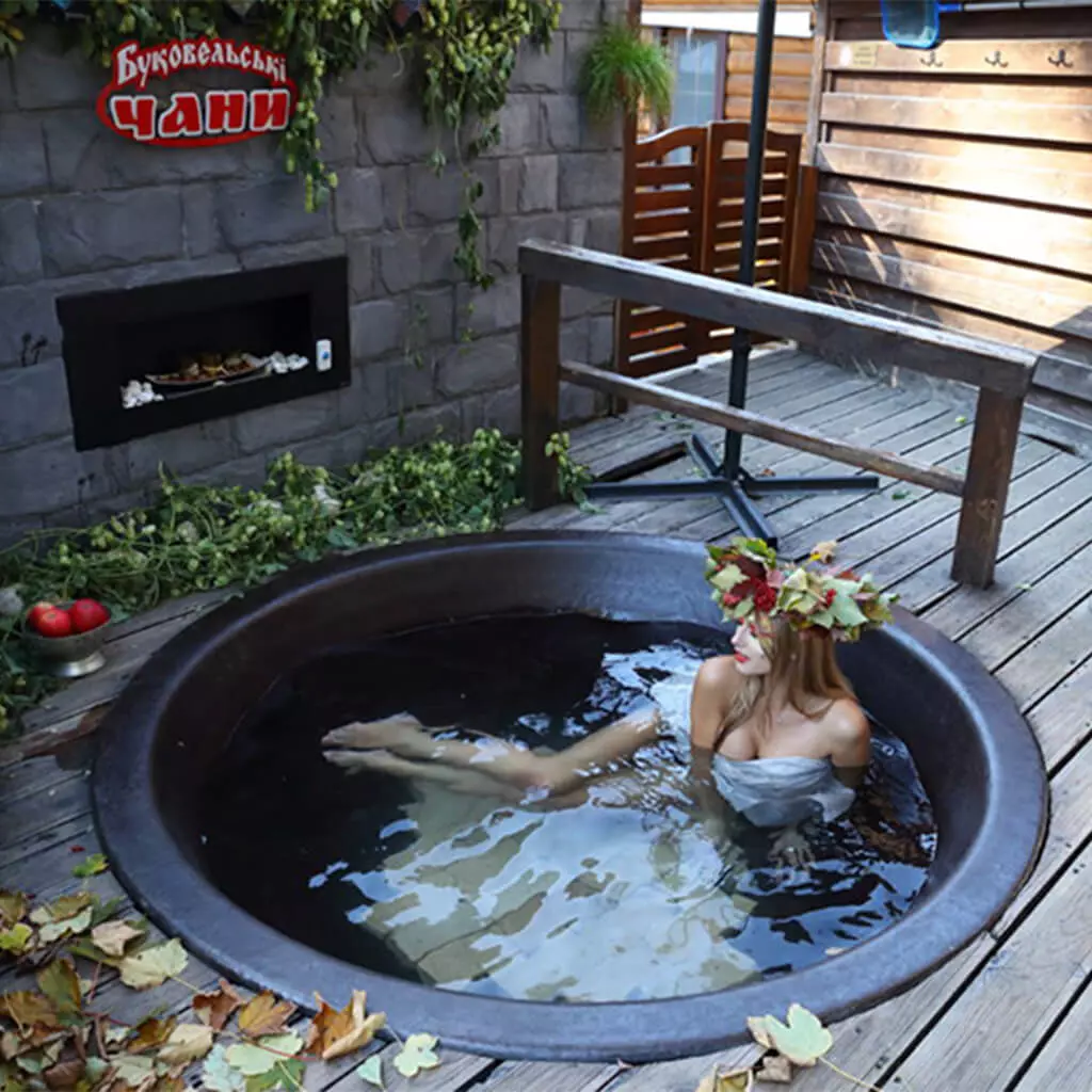 girl with a wreath lies in a hot tub bathtub
