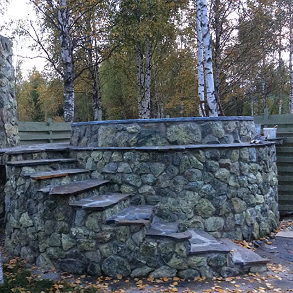 outdoor tub in a forest with natural stone
