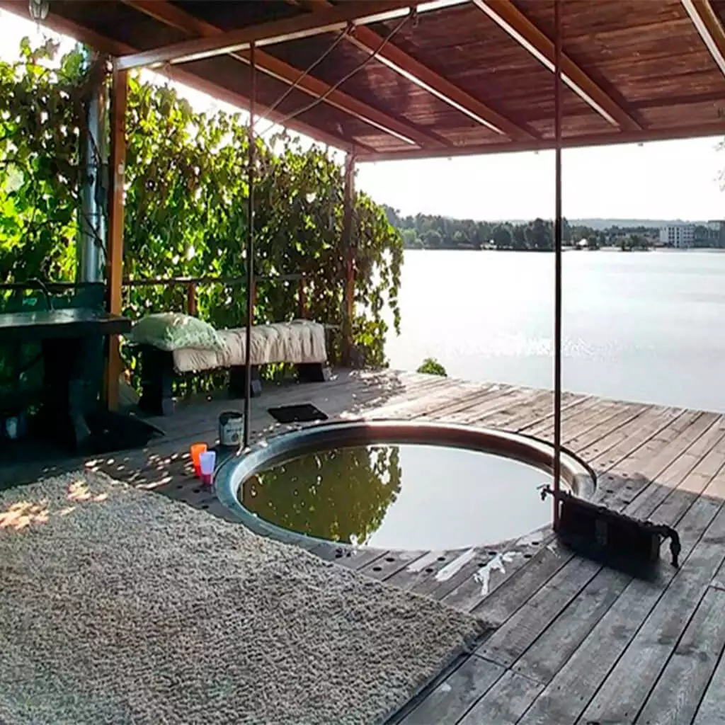 the farmstead with outside hot iron tub on the river bank